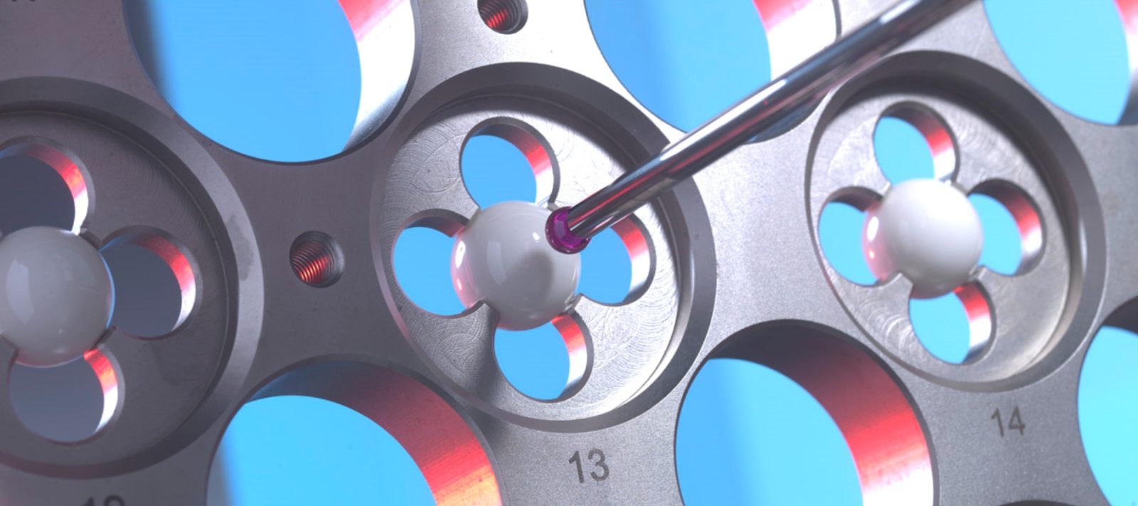 A measurement probe measuring a metal structure with circular holes.