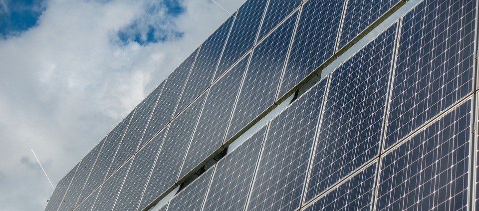 Photovoltaic system against a cloudy sky.