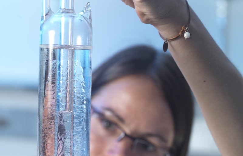 An NPL scientists examines a triple point cell.