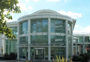 The front entrance of NPL's Teddington site on a sunny day.