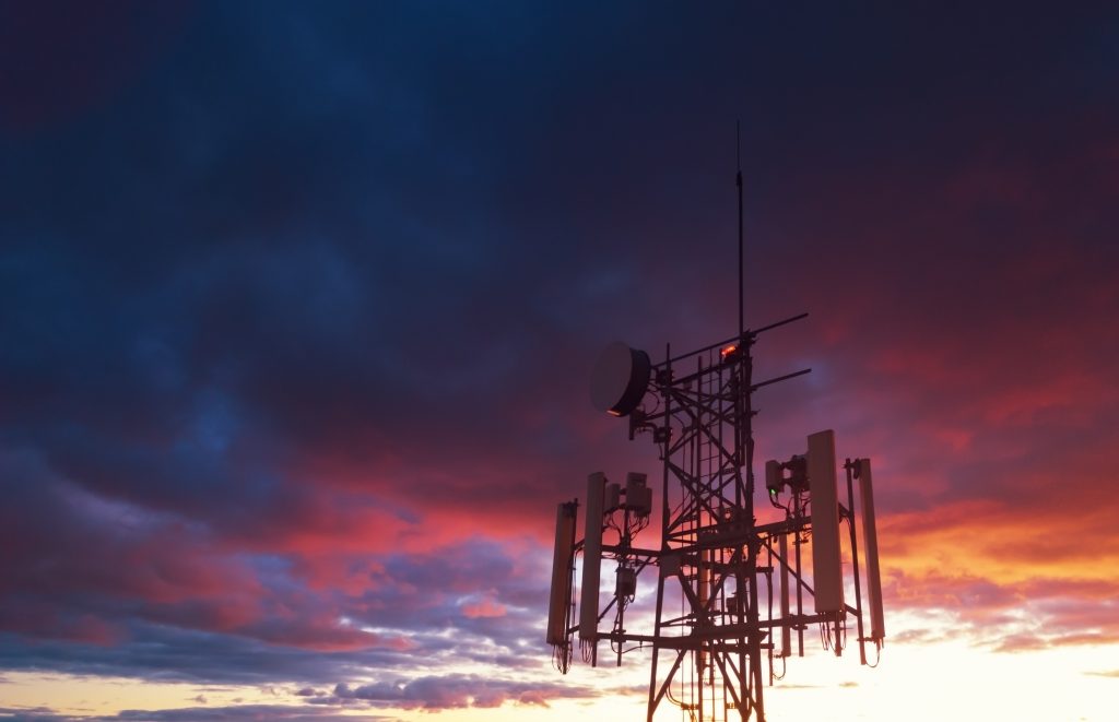 Aerial view of a cellular tower in evening light.